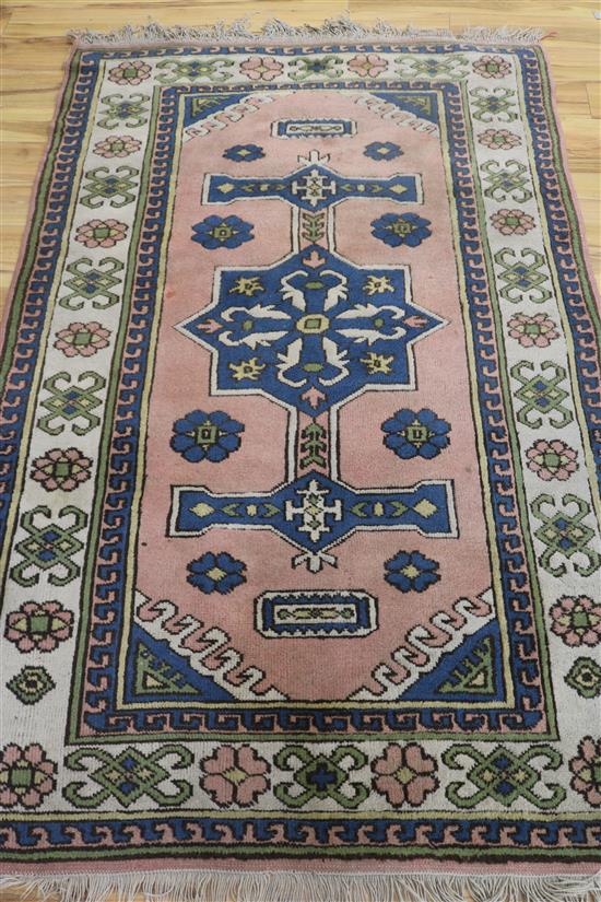 A Caucasian-style peach ground rug